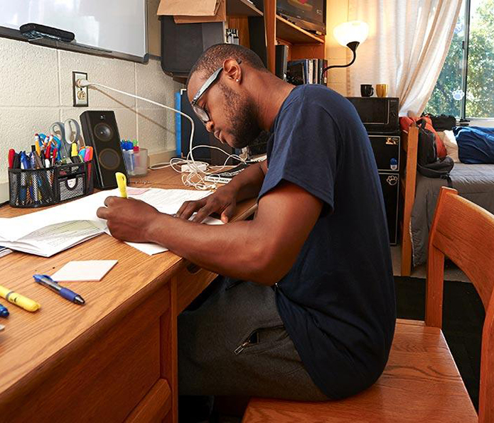 Penn State student at desk in Residence Hall